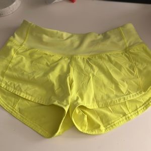 Lululemon size 0 speed up shorts in neon. Low rise 2.5 in.